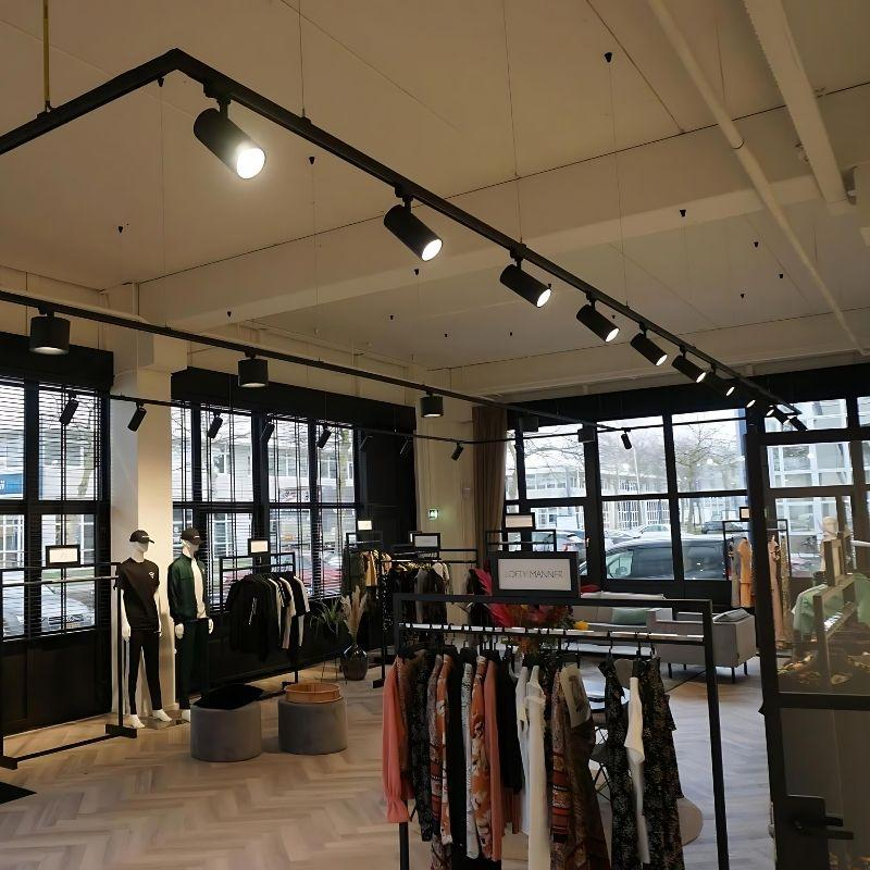 Adjustable track spotlights illuminating changing merchandise displays