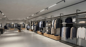 Premium flagship retail interior combining track linear LED lighting with adjustable accent spotlights in neutral 4000K light.