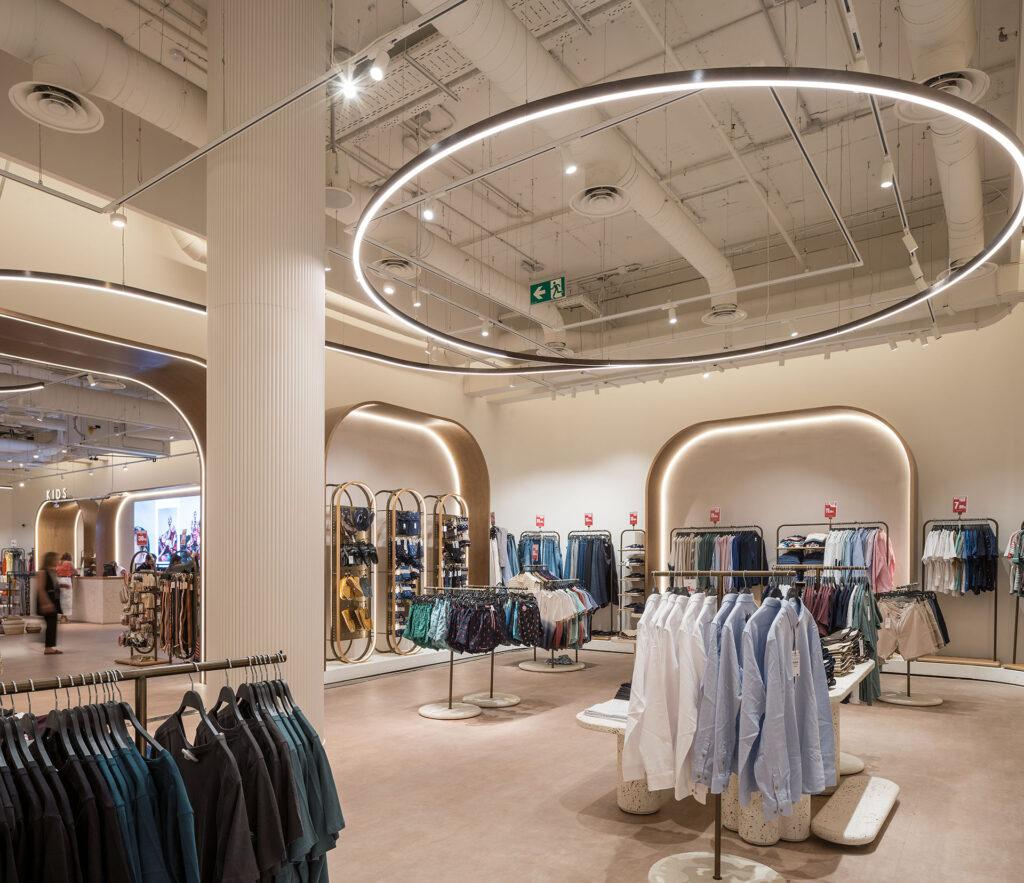 RGB lighting control for track lights, recessed downlights and circular LED luminaires in a modern retail interior.